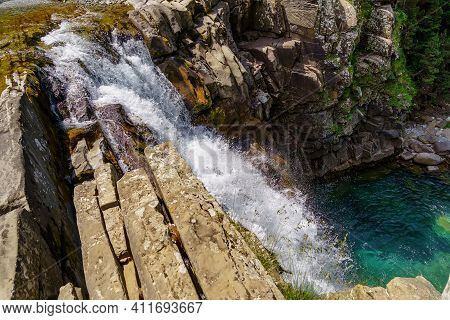 Waterfall On Steps Or Terraces In Green Landscape Between Trees And Mountains In Ordesa. Soaso Stand
