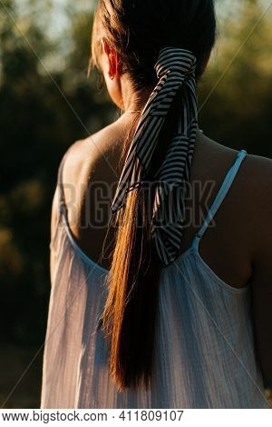 Female Hairstyle Decorated With Ribbon Close-up Back View