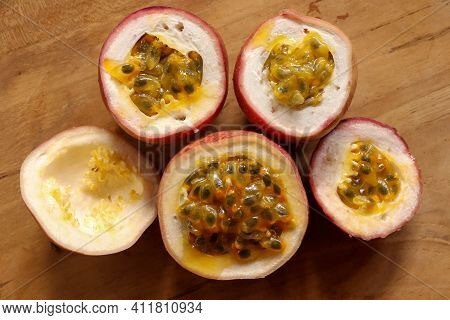 Half Cut Passion Fruit On Wooden Background. Fresh Passion Fruits-healthy Fruit And Special Taste