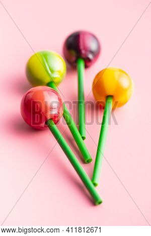 Sweet fruity lollipops on colorful background.