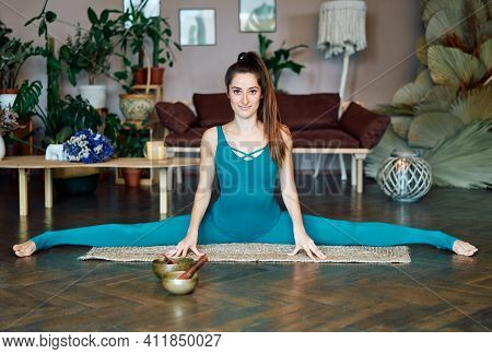 Young Sporty Woman Practicing Yoga At Home Doing Stretching Exercise The Center Split Pose, Straight