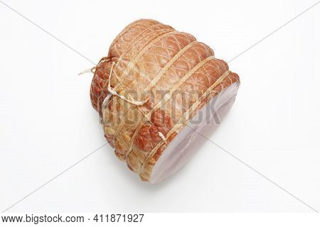 Top View Of Smoked Ham Isolated On A White Background. Homemade, Smoked Cold Cuts, In Netting, Cut, 