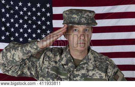 Mature Man Saluting While Wearing Military Outer Shirt Plus Cap With Us Flag In Background