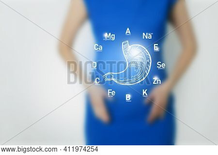 Graphic Visualization Of Healthy Human Stomach Surrounded With Icons Of Vitamins And Minerals. Blurr