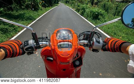 Scooter Road Trip. Pov View, First Person. Men On Red Motorbike In White Clothes On Drive Forest Roa
