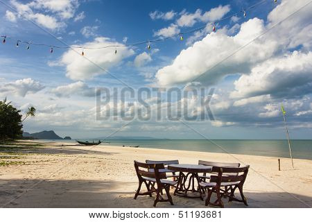 Table and seats on deserted and relaxing tropical Khanom beach, Thailand