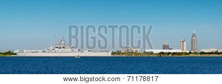 Panoramic Of Mobile, Alabama, Skyline With U.s.s. Alabama In Foreground On Mobile Bay