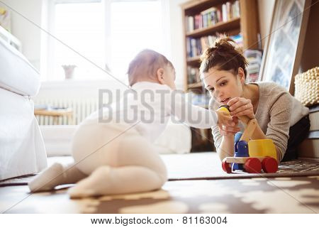Little baby girl playing with her mother