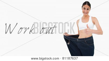 Smiling woman who lost a lot of weight the thumbup against white background