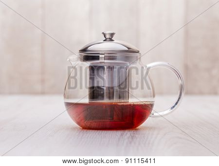 the glass teapot tea, on woodwn table