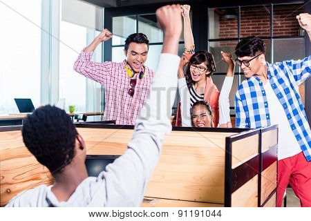 Start-up business people in cubicles working together having success
