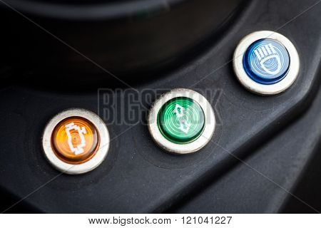 Color close up image of the neutral switch check engine and high beam indicators on a motorcycle.
