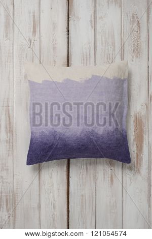 Square Gradient Purple Throw Pillow Laid Flat On Wooden Surface