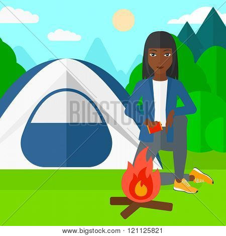 Woman kindling fire.