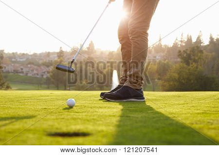 Close Up Of Male Golfer Putting On Green
