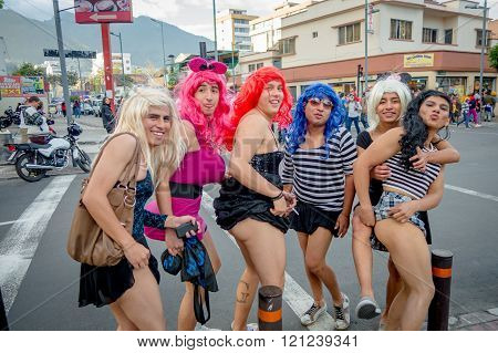 Quito, Ecuador - January 26, 2015: Five guys dreessed with womans clothes celebrating new yearsdurin