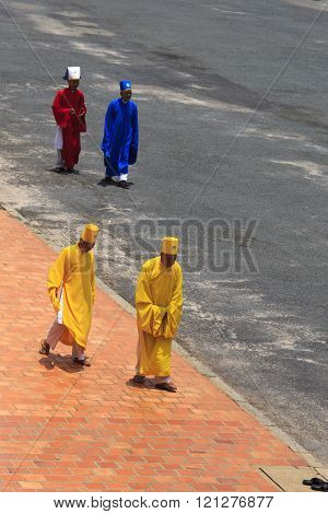 Priest Going In A Caodai Temple In Vietnam