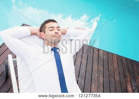 Smarty dressed relaxing near poolside on sun lounger