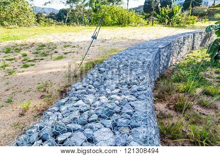 Slope Earth Retention Wall With Rocks And Wire Mesh Cage
