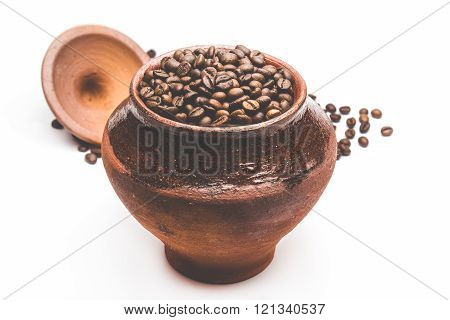 Grains of coffee in a decorative pot