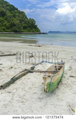 Traditional fisherman wooden boat with cloudy skies at Lombok Selatan Indonesia