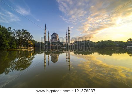 SELANGOR MALAYSIA - JANUARY 30 2016: The Beautiful Sultan Salahuddin Abdul Aziz Shah Mosque (also known as the Blue Mosque) with nature sunrise lighting and reflection.