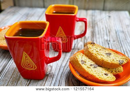 Dessert two cups with espresso coffee and amandel cantuccini on rustic wooden backgound