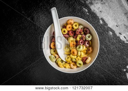 A top view shot of a bowl of colorful cereal.