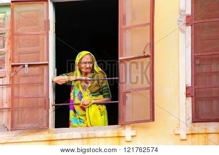JAIPUR, INDIA - NOVEMBER 13: Unidentified woman looks out of the window on November 13, 2014 in Jaipur, India. Jaipur is the capital and the largest city of  Rajasthan.