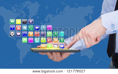 Businessman holding a tablet pc with mobile applications icons on virtual screen . Internet and busi