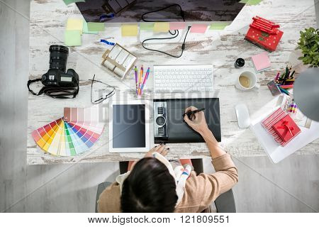 woman designer working on the pen table in office top view