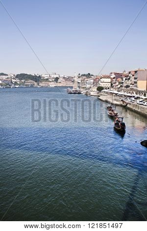 Porto, Portugal old town skyline on the Douro River with rabelo boats.