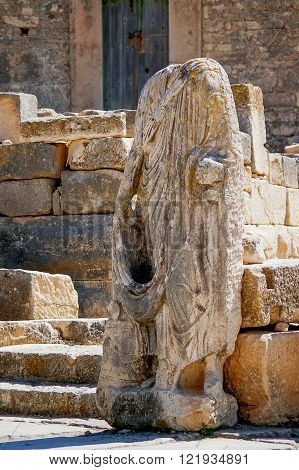 Ancient statue in Dougga Roman Ruins: A Unesco World Heritage Site in Tunisia. Ruins of the roman City of Dougga with the Capitol.