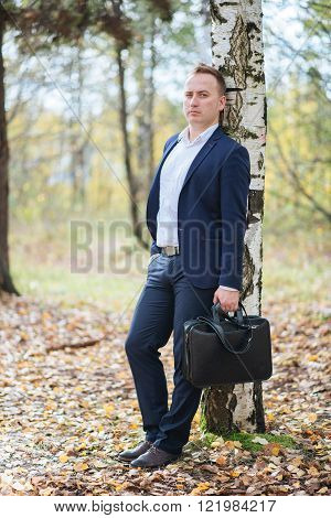 portrait of middle aged businessman walking in the nature