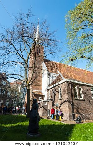 Amsterdam Netherlands-April 30: The English Reformed Church main building at Begijnhof on April 302015. The Begijnhof is one of the oldest inner courts in the city of Amsterdam.