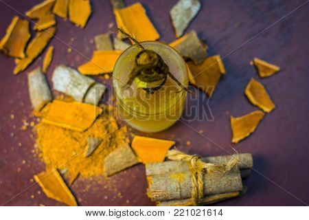 Close Up Of Oil Of Cinnamon,cinnamomum Zeylanicum  With Whole Cinnamon And Its Powder.