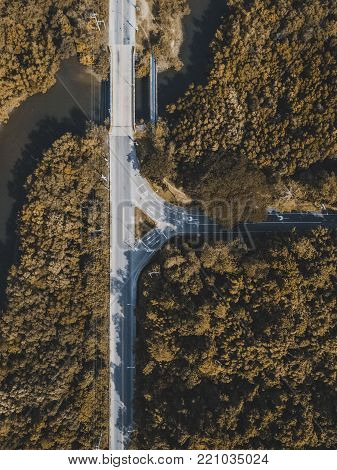 drone view of a highway and a river in the forest
