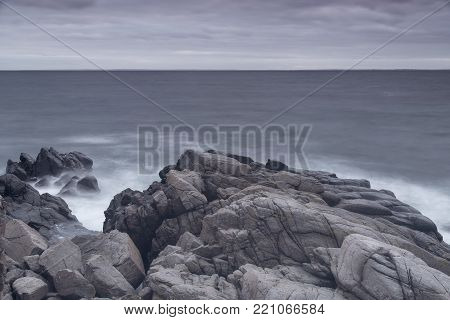 Rocky beach landscape at dusk. Kullaberg, Sweden.