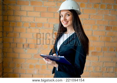 A portrait of a female archtect on construction site