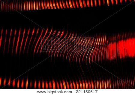 Red and black colors abstract background blur of street lights. Striped lines and spots. View through the window of polycarbonate, Long exposure.