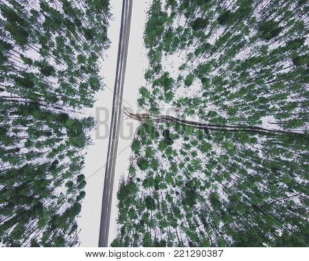 Aerial Drone Photography of a Road in Winter, Between Woods with a Snow