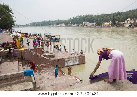 Rishikesh, India - June, 24, 2015 view of people in Ganga river embankment in Rishikesh, Rishikesh is one of sacred city of hinduism.