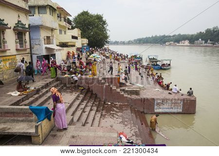 Rishikesh, India - June, 24, 2015 view of people in Ganga river embankment in Rishikesh, Rishikesh is one of sacred city of hinduism.