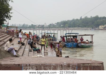 Rishikesh, India - June, 24, 2015 view of people in Ganga river embankment in Rishikesh, Rishikesh is one of sacred city of hinduism.