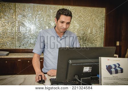 Handsome Hotel Manager At The Front Reception Desk