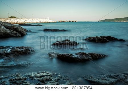 Sea wave impact with rock streak like a boil water with clear sky, Khao Leam Ya National Park at Rayong of Thailand (Long Exposure Technique photograph)