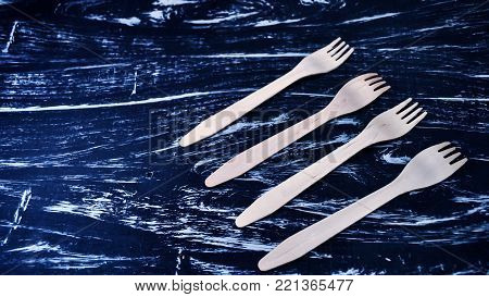 Silver fork lying on a wooden table.