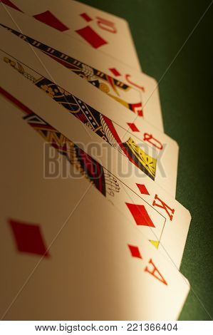 CLECKHEATON, WEST YORKSHIRE, UK: HAND OF PLAYING CARDS SHOWING ROYAL FLUSH ON GREEN CLOTH GAMING TABLE, CIRCA 2007, CLECKHEATON, WEST YORKSHIRE, UK