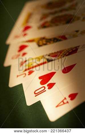 CLECKHEATON, WEST YORKSHIRE, UK: HAND OF PLAYING CARDS SHOWING ROYAL FLUSH ON GREEN CLOTH GAMING TABLE, CIRCA 2007, CLECKHEATON, WEST YORKSHIRE, UK