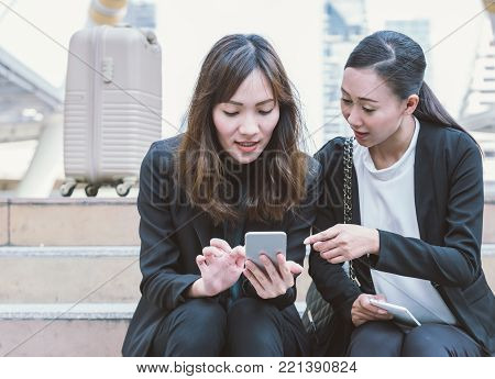 Group of happy Asian business colleagues laughing and talking enjoy outside the office.